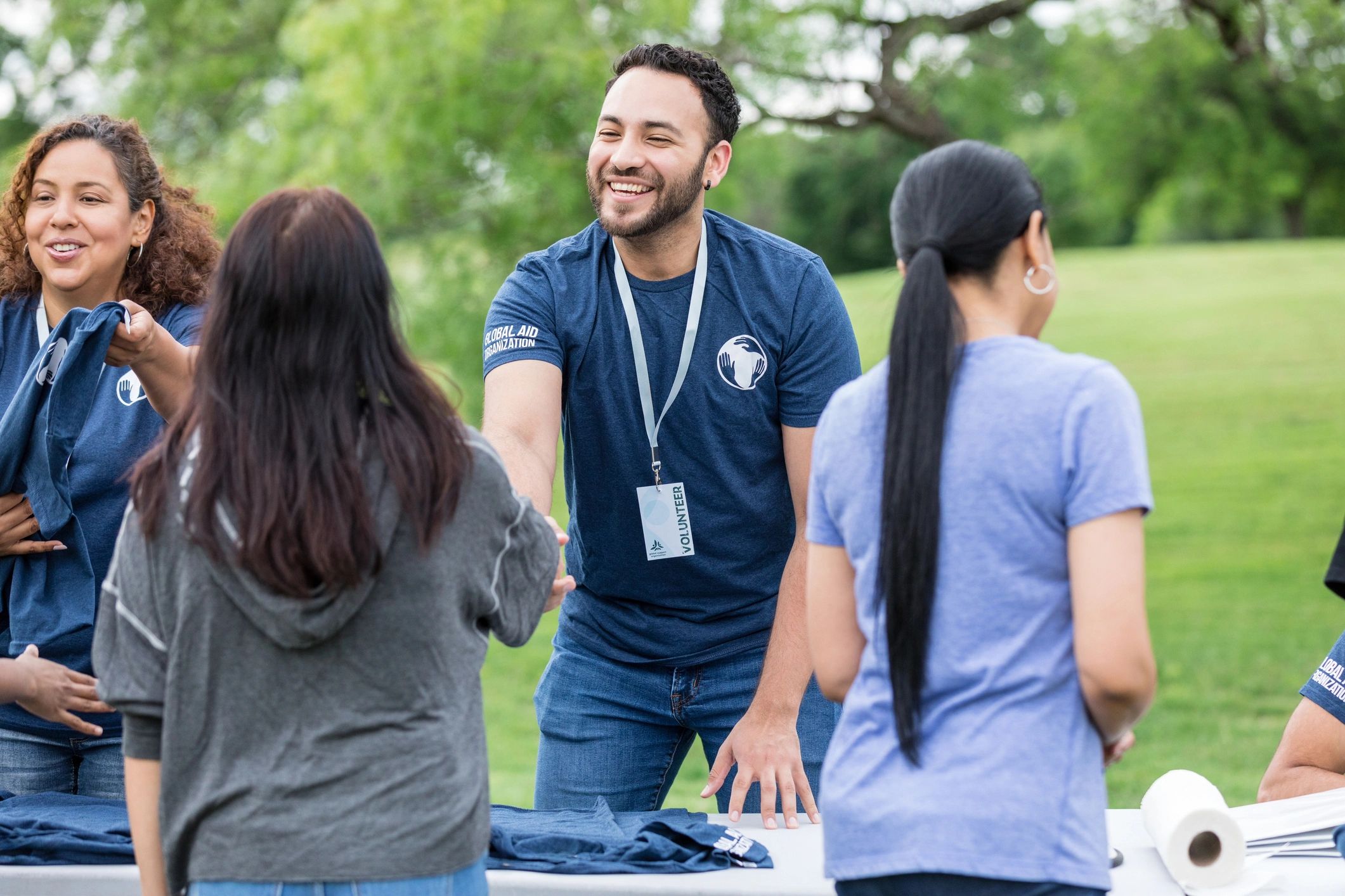 Volunteer greeting a community member with warmth and respect