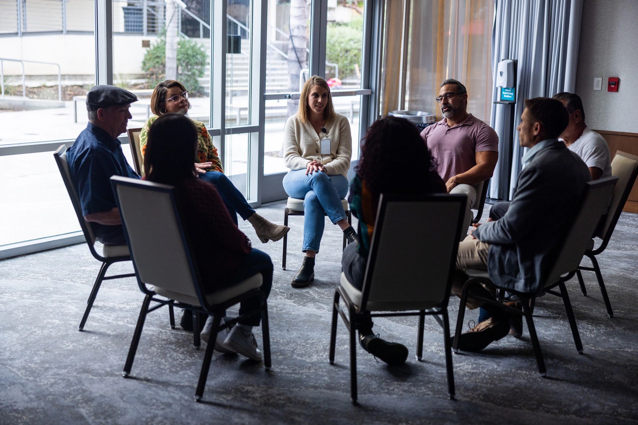 Support group gathered in a bright community space